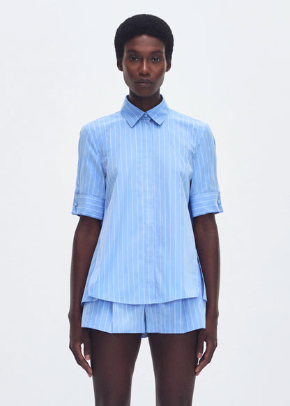 model wearing the trapeze shirt in stripe poplin in pale blue 