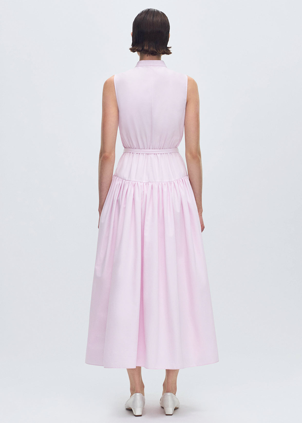 back profile of model wearing the Arden Dress in Compact Cotton in Pale Pink