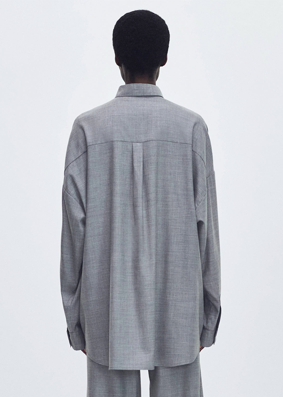 Back Profile of model wearing the Perrine Shirt in Fine Cashmere Suiting in Grey