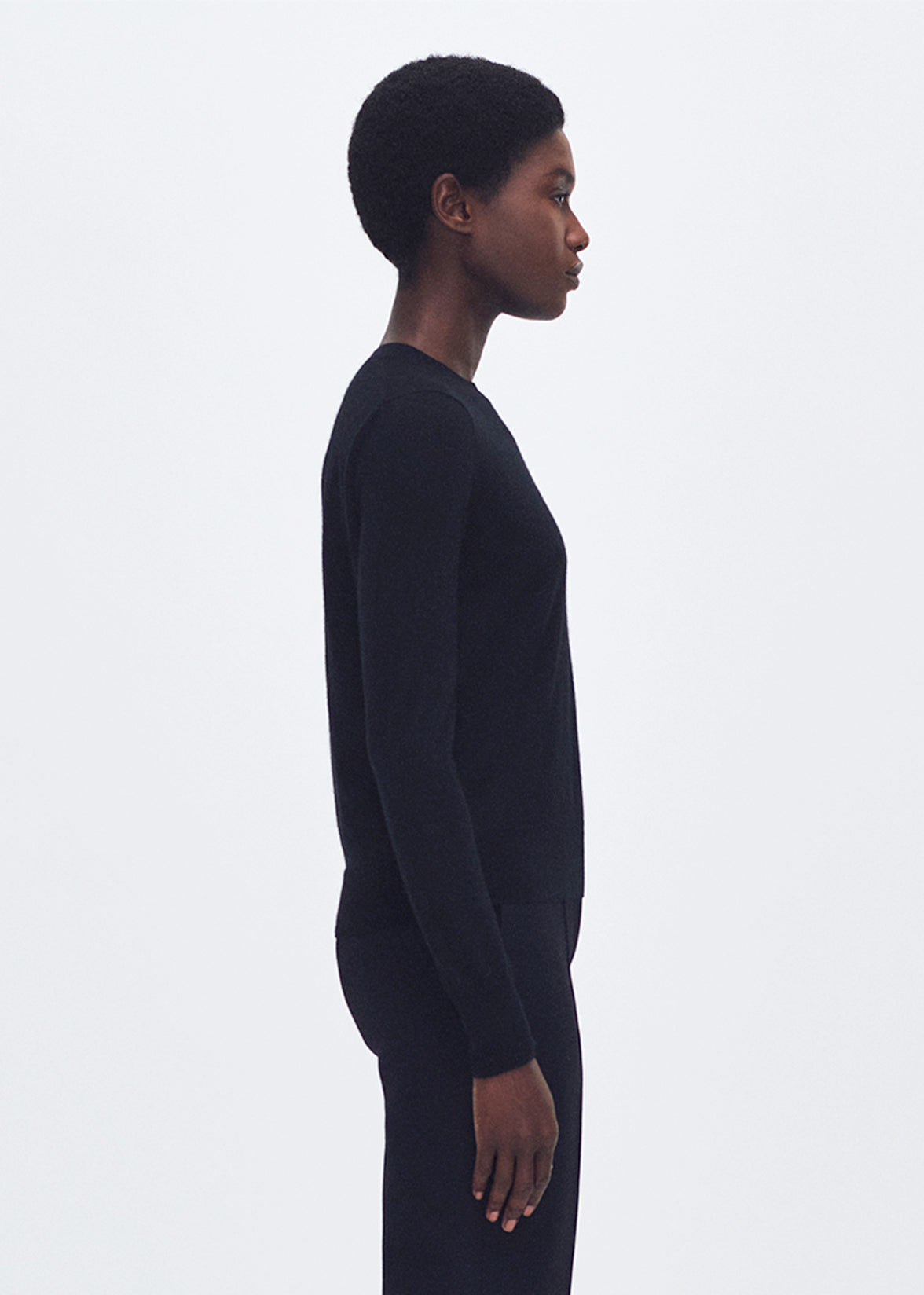 side profile of model wearing the Didion Knit in Cashmere in black