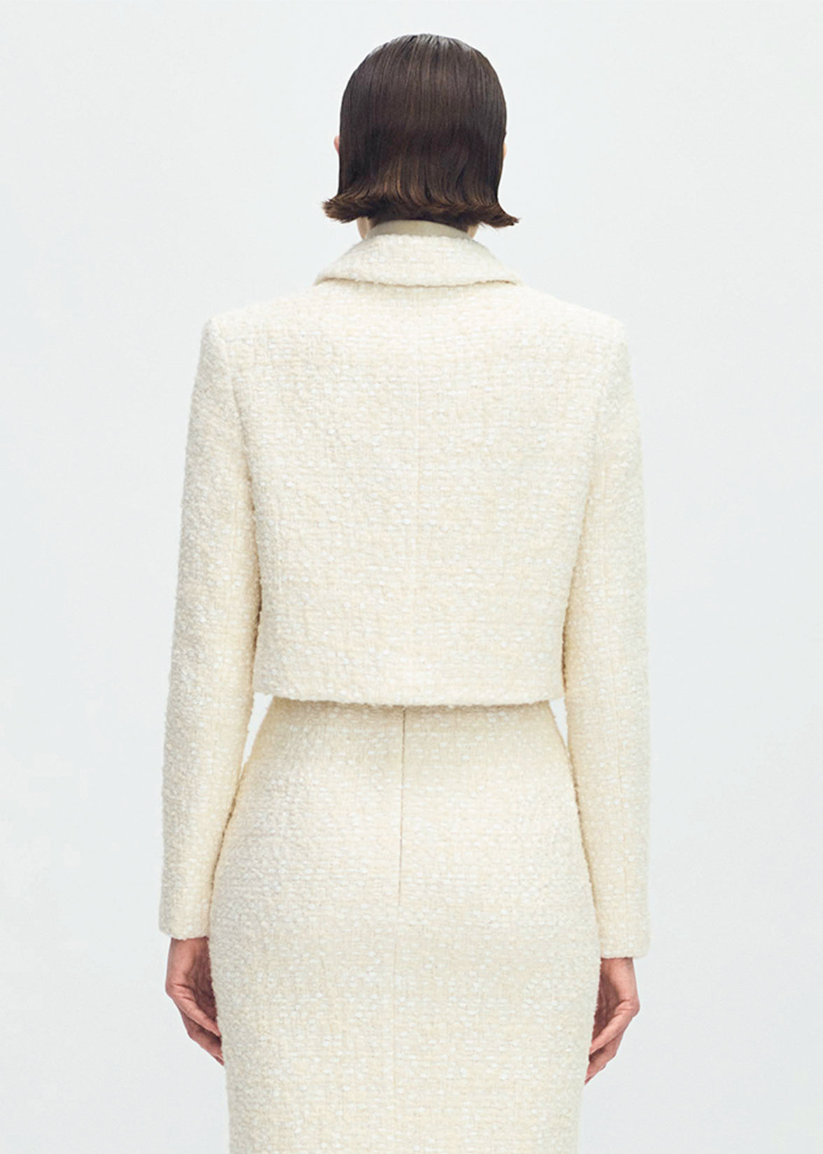 back profile of model wearing the cecil jacket in tweed in ivory