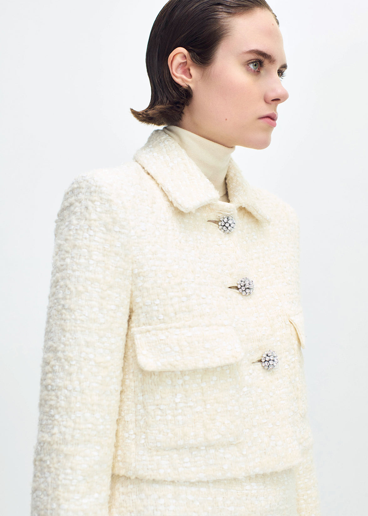 close up front profile of model wearing the cecil jacket in tweed in ivory