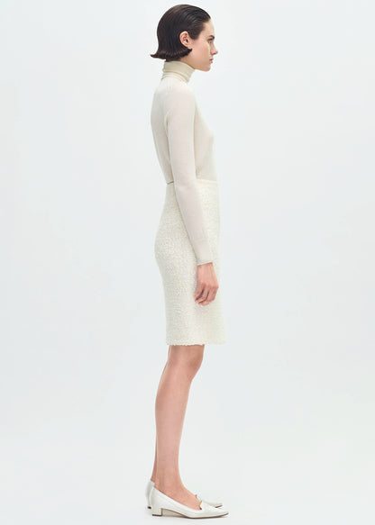 side profile of model wearing the Blair Skirt in Tweed in Ivory