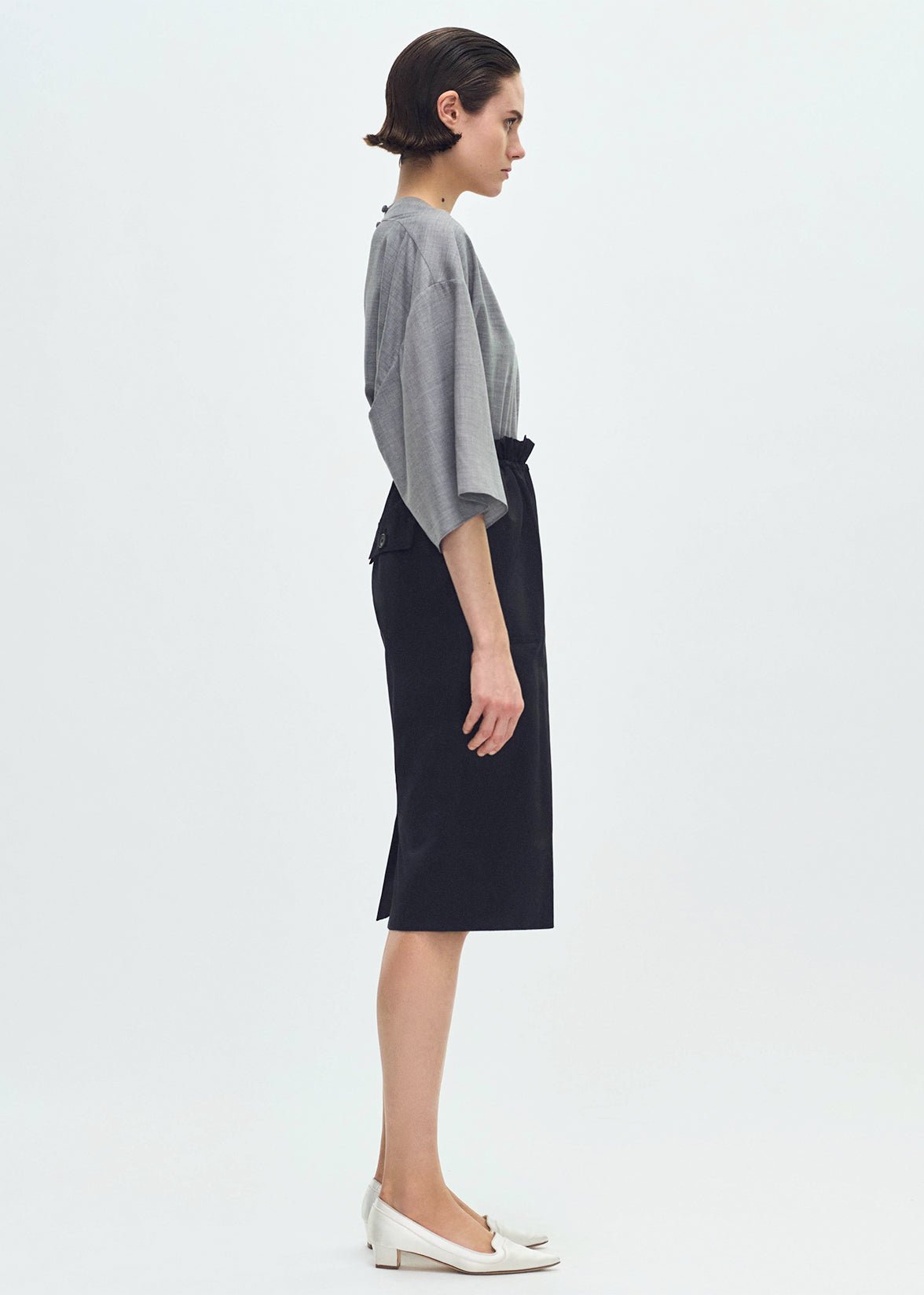 Side profile of model wearing the Sullivan Skirt in Silk Cotton Duchesse