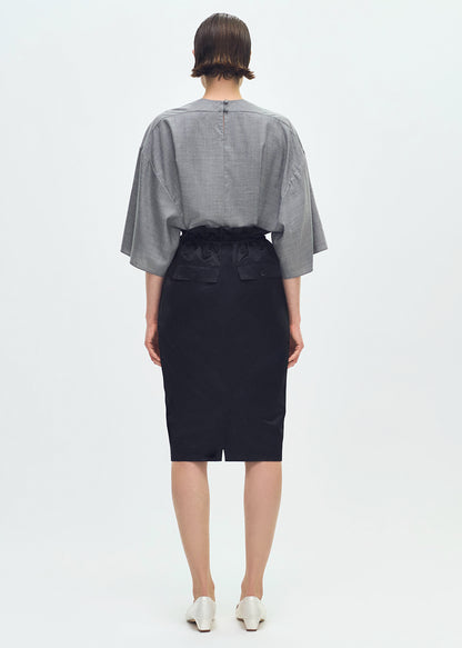 Back profile of model wearing the Sullivan Skirt in Silk Cotton Duchesse