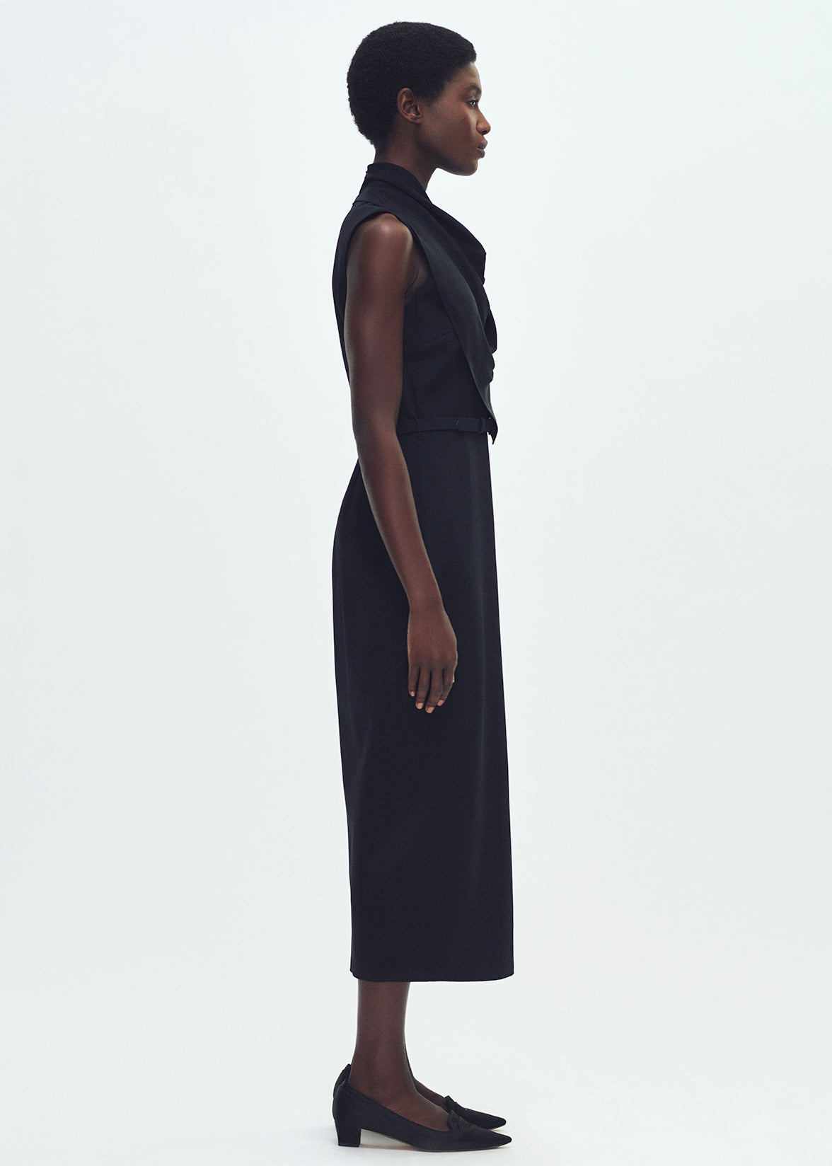 Side profile of model wearing THE BANDERA DRESS IN SILK CREPE IN
BLACK