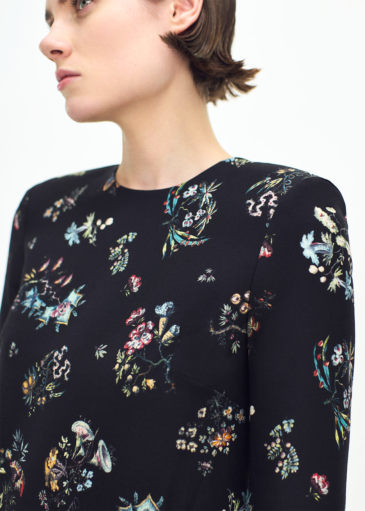 close up profile of model wearing the Tilley dress in black floral