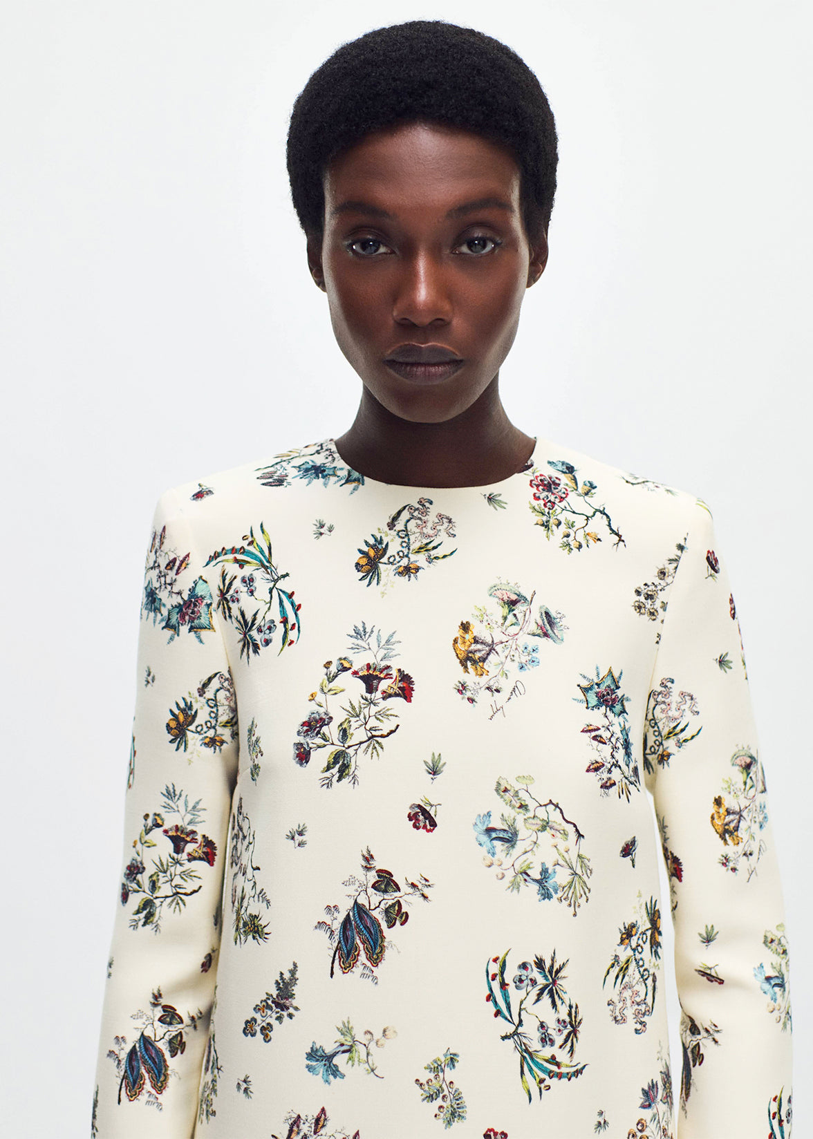 close up profile of model wearing  the tilley dress in printed silk wool ivory floral