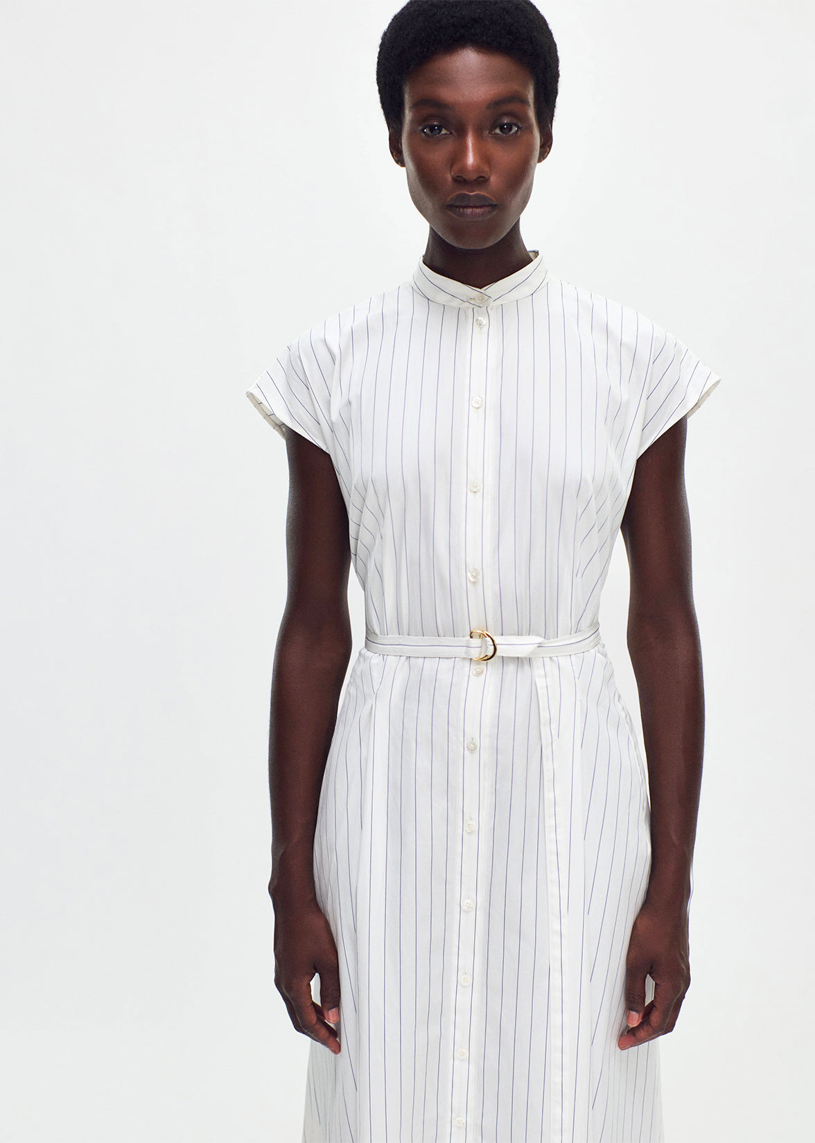 model wearing the DEJEUNER DRESS IN STRIPE POPLIN in pale white