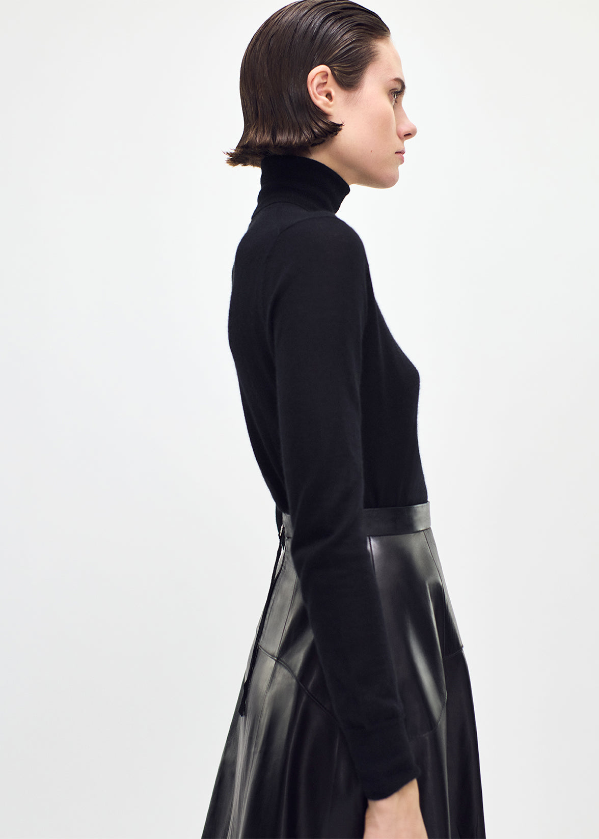 side profile of model wearing the Eve Knit in cashmere knit in black