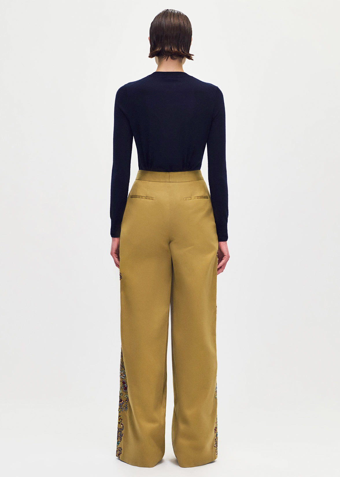 back profile of model wearing the Nils Pant in Embroidered Cotton Twill