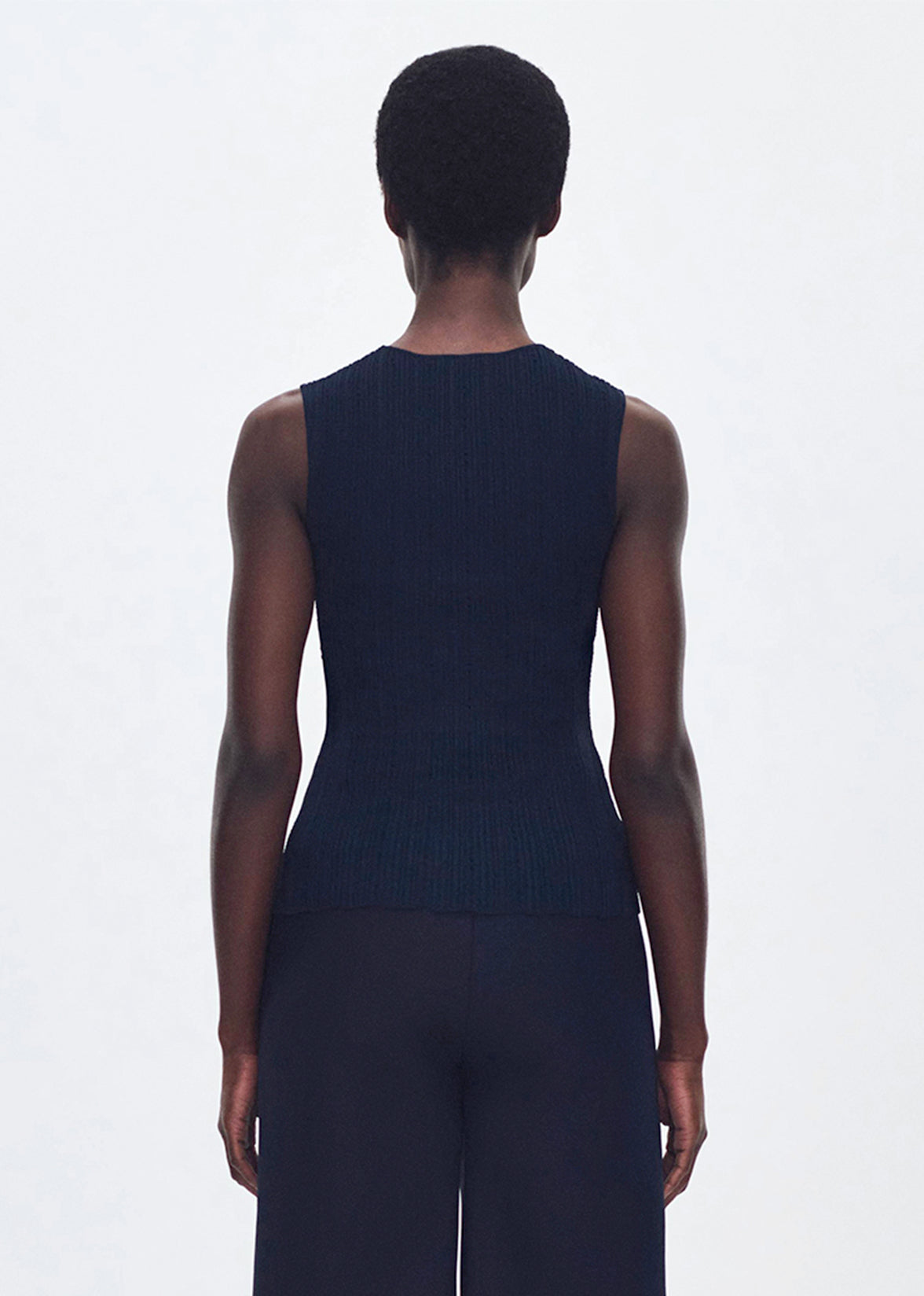 back profile of model wearing the brynn top in compact jacquard in navy