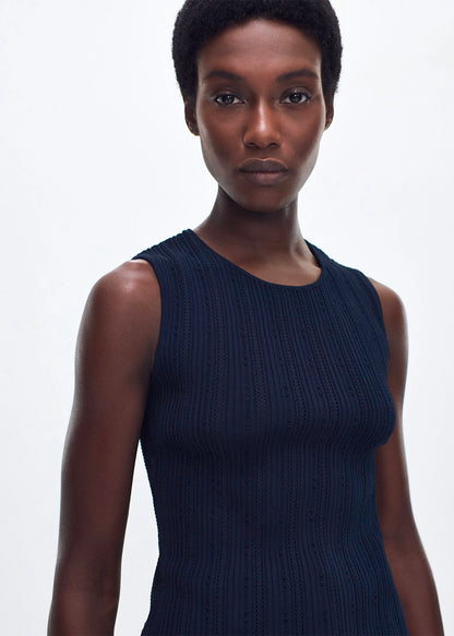 close up of model wearing the brynn top in compact jacquard in navy