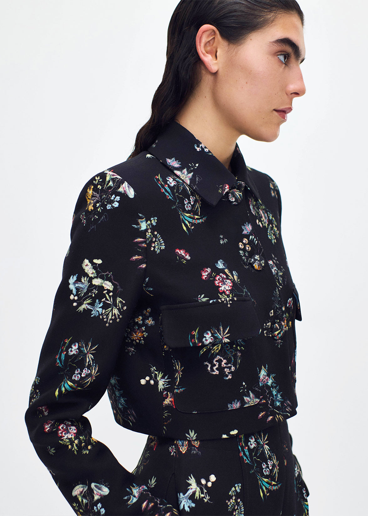 close up profile of model wearing the cecil jacket in printed silk wool in black