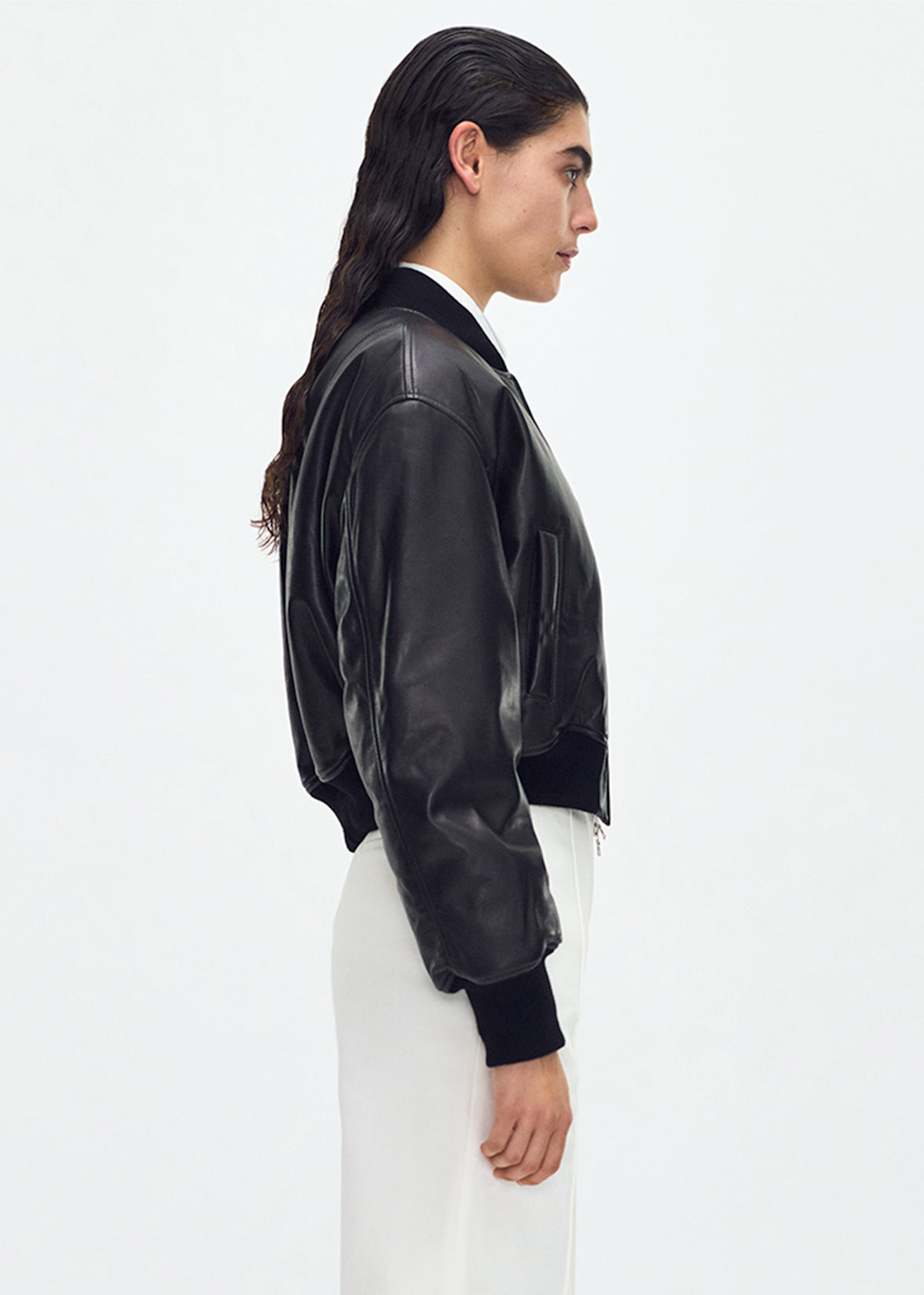 side profile of model wearing the Bomber Jacket in Black Leather