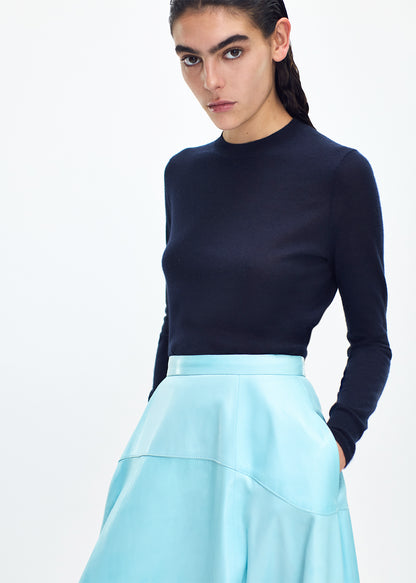 close up profile of model wearing the cody skirt in leather in aqua