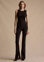 Model wearing the Eva Flare Pant in black with the Ribbed Shell Top in black.