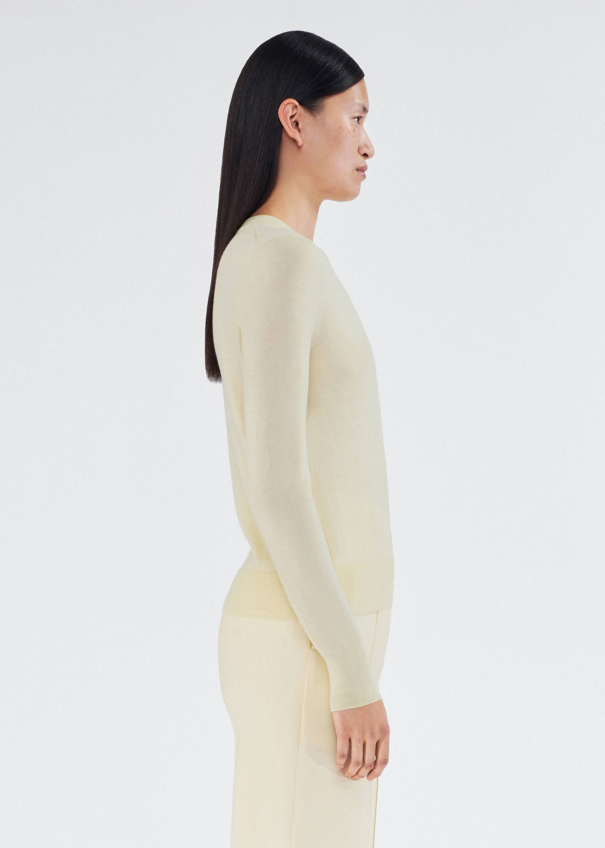 Side of model wearing Crewneck Sweater in Cashmere Silk in Buerre