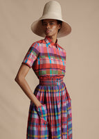 A model posing with her hand inside of the pocket of the Lovisa Skirt with Smocked Waist in Printed Voile. She is also wearing the Trapeze Shirt in Printed Voile and the Cleo Hat.