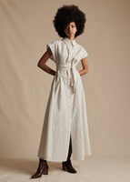 Model is wearing the striped, short-sleeve Dejeuner Dress with a belt knotted at the middle.