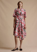 Model is wearing the Asymmetrical Dress with sleeves in printed poplin in the Ivory Floral print