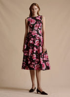 Model is wearing the cotton twill Eloise Dress in the black and pink multi floral pattern. The dress is midi length.
