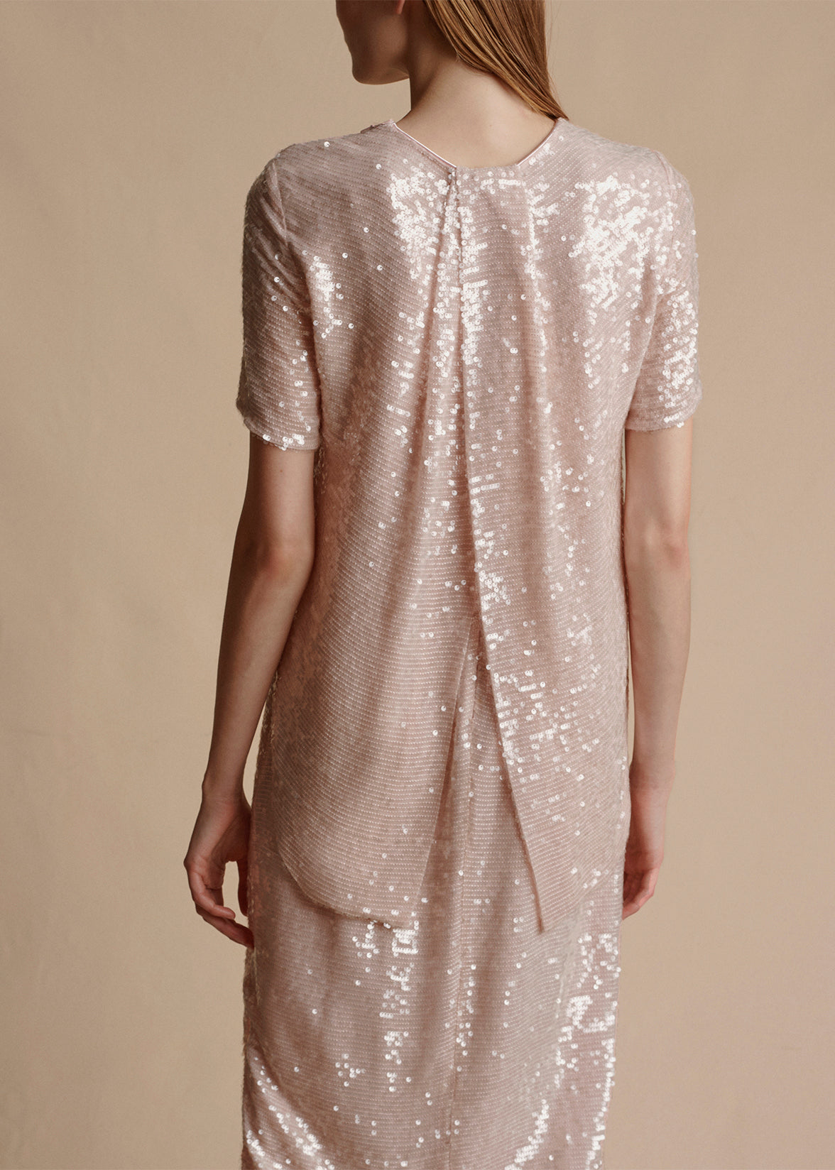 Showing the back of the sequin shirt, including the split hem by Adam Lippes