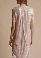 Showing the back of the sequin shirt, including the split hem. 