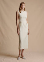 Model is wearing the fitted waist Ophelia Dress in Silk Wool. The dress is sleeveless and midi length.