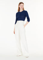 Full body image of a model wearing the parker henley in cashmere silk rib knit in navy.