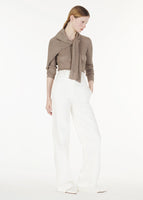 Full shot of model wearing the Parker Henley in Cashmere Silk Rib Knit with the Hugo Pant in White Denim.