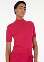 Close up of a model wearing the mockneck top in ultra fine cashmere in magenta