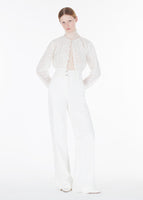 model wearing the malone cardigan in pleated lace knit paired with the hugo pant in white denim