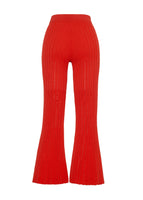 A flat lay of the back of a cropped flare red pant with pointelle stitch.