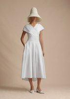 A model wearing the Sibyl Dress in Cotton Poplin, paired with the Cleo Hat.