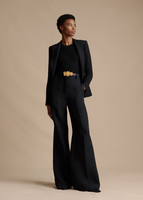 A model wearing the Floral Garland Buckle Belt, paired with the Deeda Pant in Silk Wool.