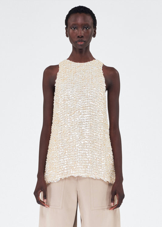 model wearing remi top by adam lippes in embroidered mother of pearl