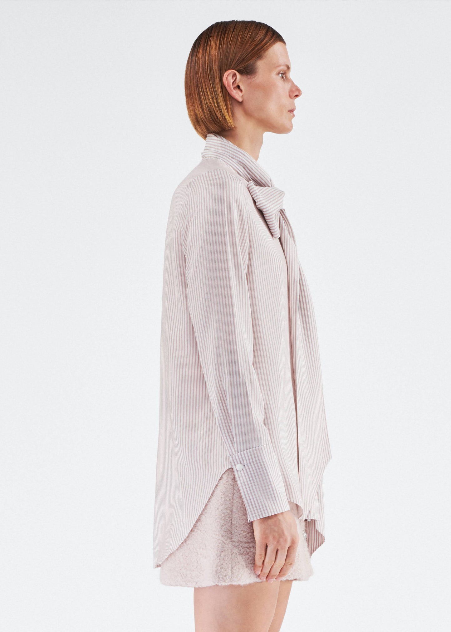 Side of model wearing the Lee Blouse in Silk Stripe in Blush/Ivory