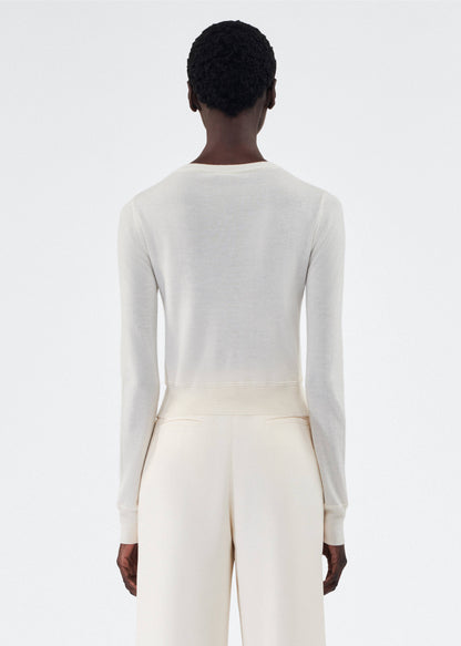 back view of model wearing the adam lippes cardigan in cashmere silk in ivory