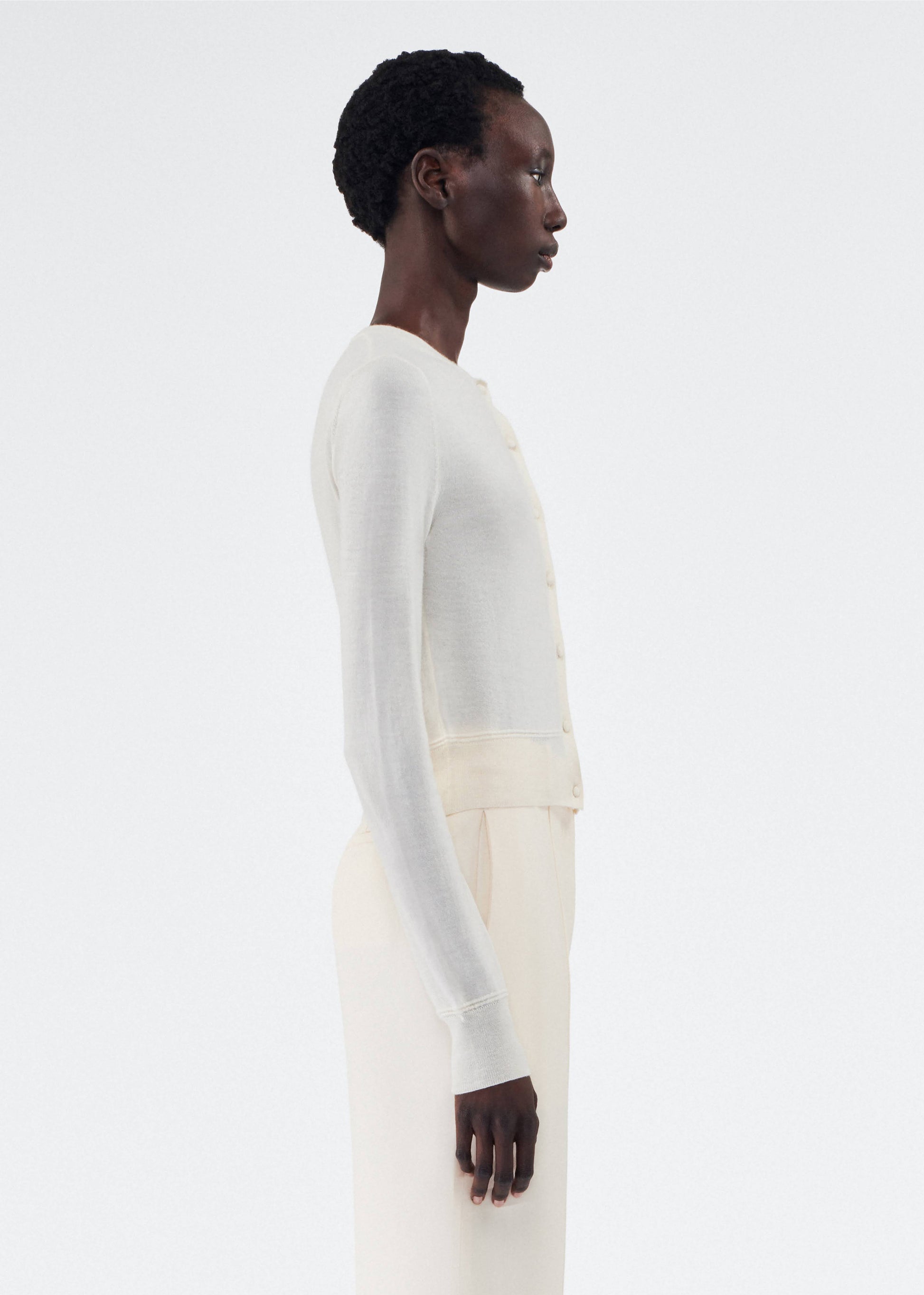 side view of model wearing the adam lippes cardigan in cashmere silk in ivory