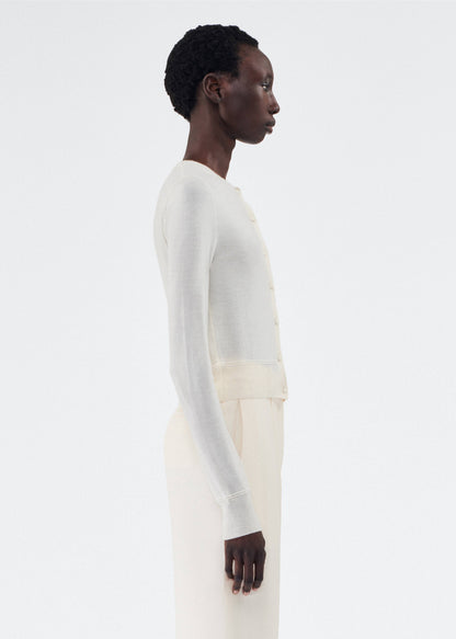 side view of model wearing the adam lippes cardigan in cashmere silk in ivory