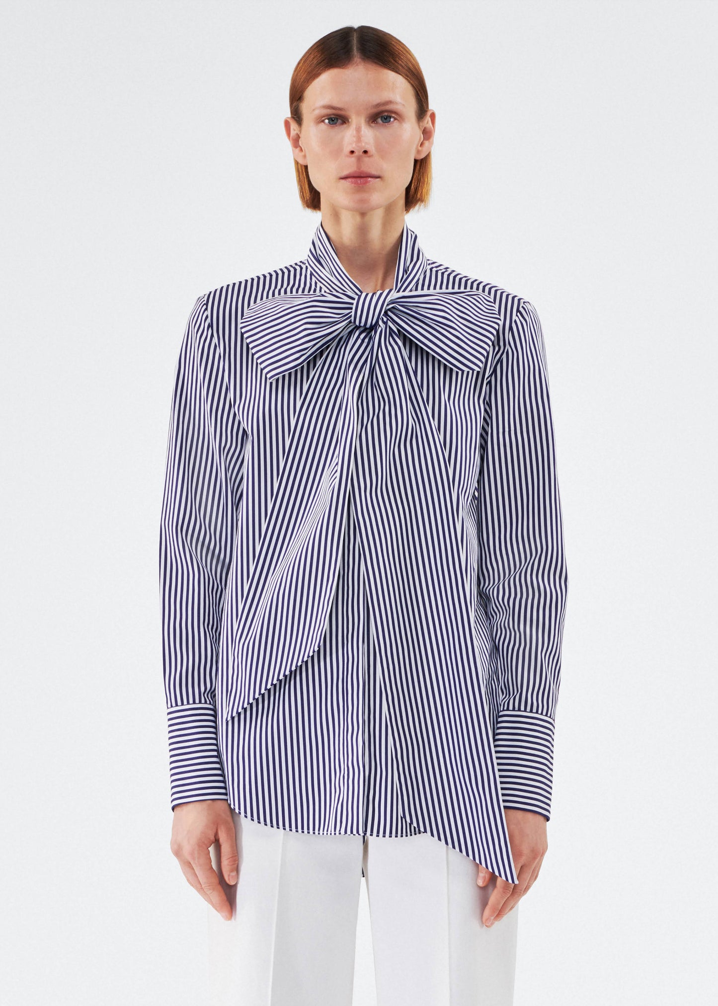 model wearing lee blouse by adam lippes in striped poplin in navy and white