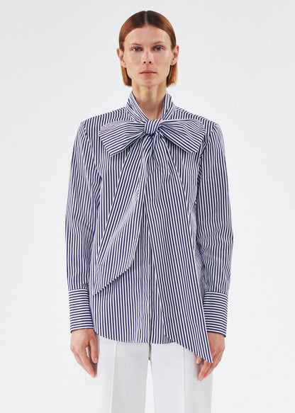 model wearing lee blouse by adam lippes in striped poplin in navy and white