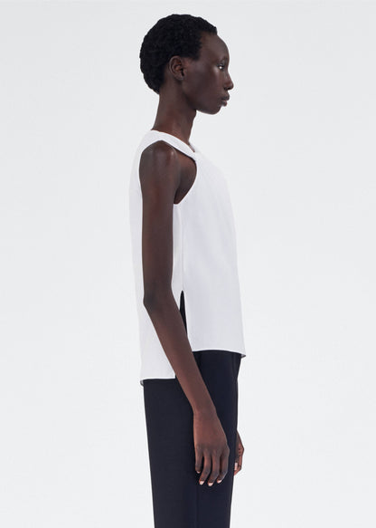 side view of model wearing feyda top by adam lippes in compact cotton poplin in white