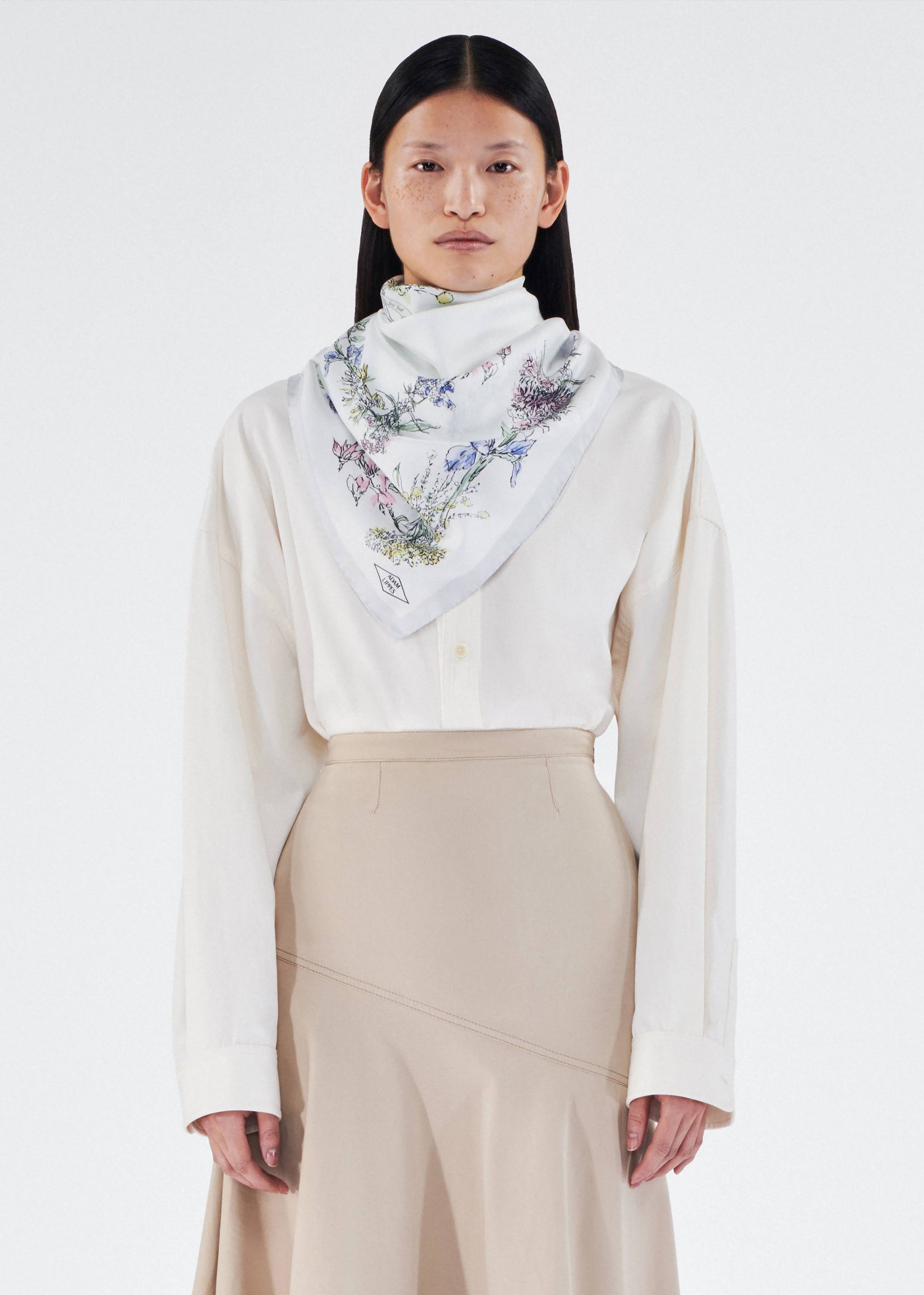 model wearing 34x34 scarf in printed silk twill by adam lippes in multi ivory floral