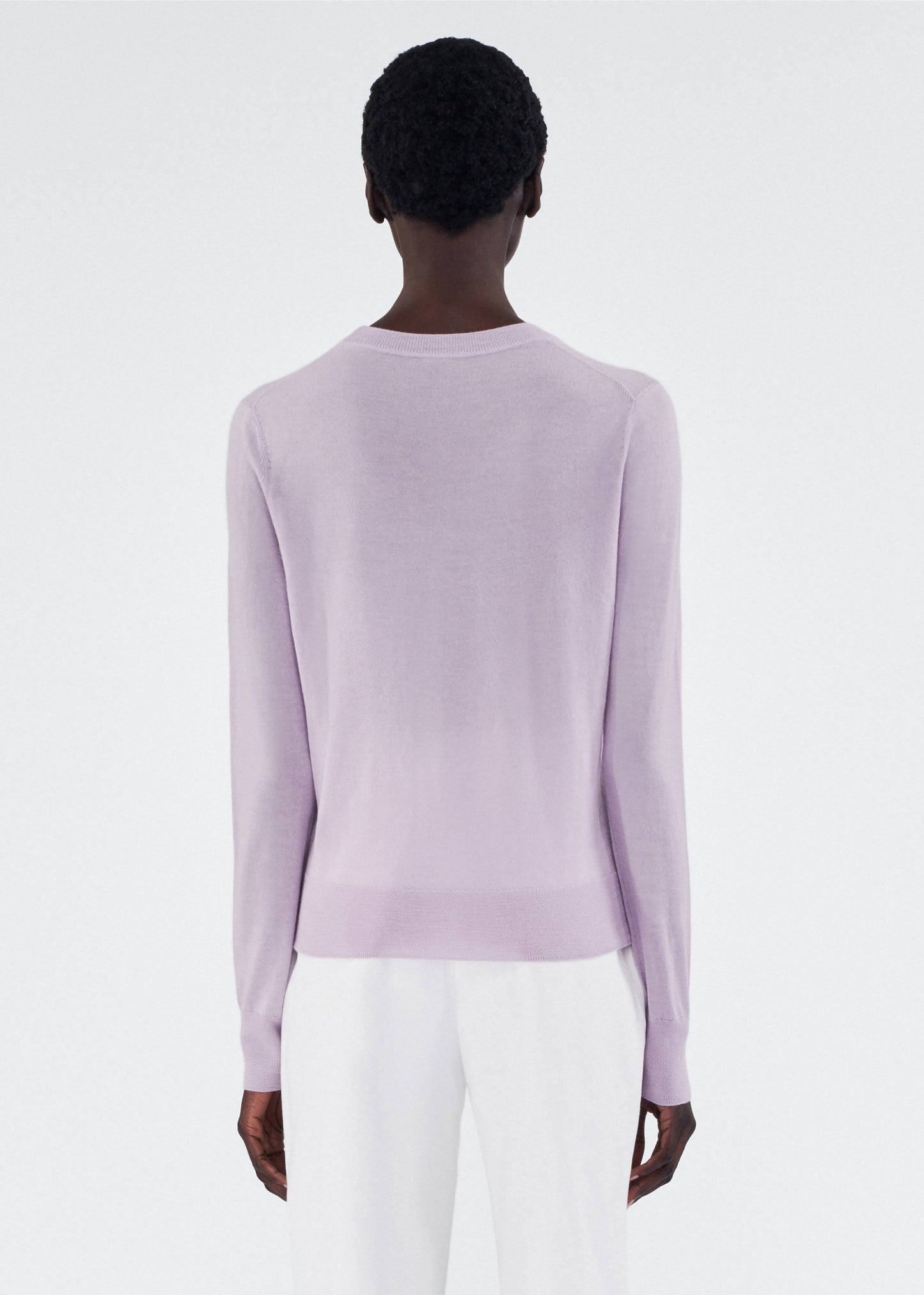 back view of model wearing the adam lippes caridgan in cashmere silk in lilac