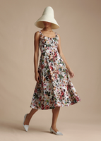 Model is wearing the Ivory Cleo hat and the Amelie Dress in Printed Cotton Twill.