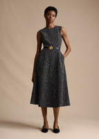Model posing and wearing the Eloise Dress in Corded Tweed with the Double Knot Belt.