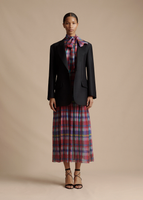 A model standing forward wearing the Tux Jacket in Radzimir Wool over the Sigrid Dress in Madras Chiffon.