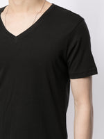 Model is wearing a black short sleeve v-neck t-shirt in pima cotton.
